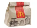 A McDonalds paper bag, made from paper, which comes directly from wood taken from tree trunks.